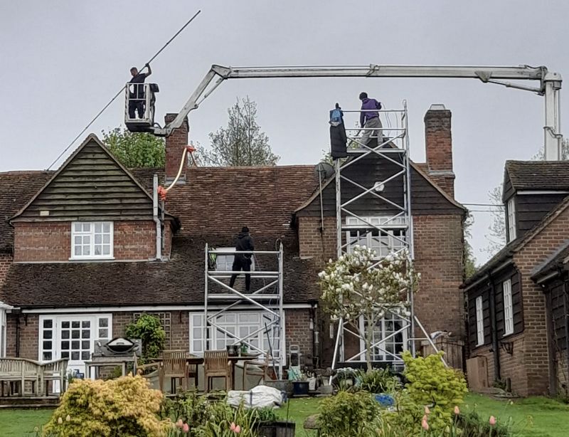 The Roof Moss Cleaners using cherry picker and scaffolding to clean roof safely and professionally in Blackwater, Hampshire